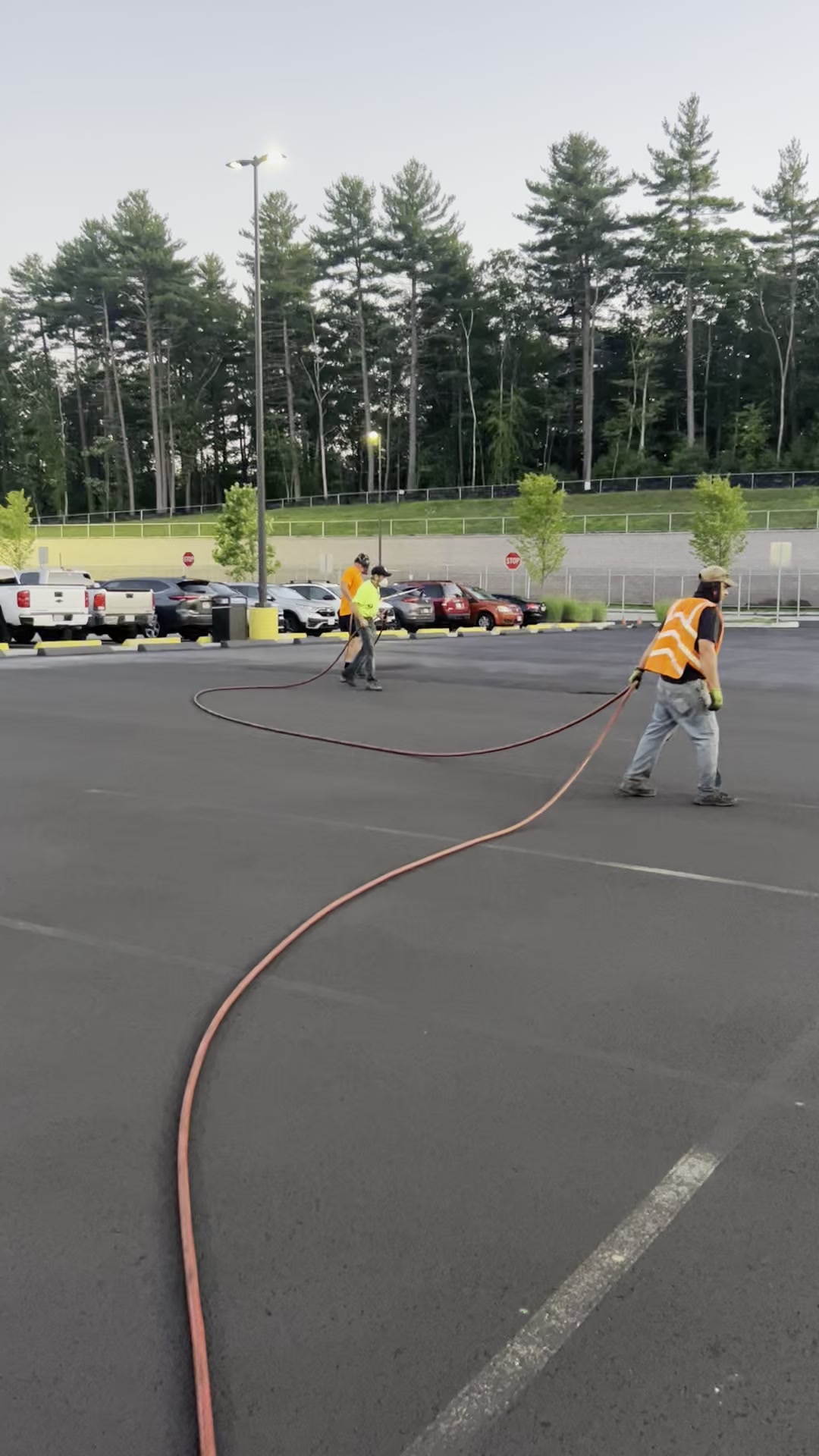 Crew sealcoating commercial lot