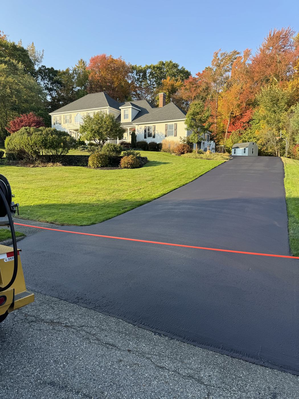 Residential driveway with protected asphalt surface