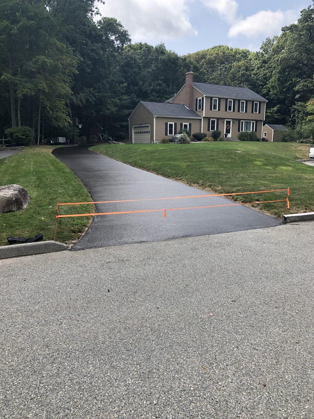 Long residential driveway freshly sealed